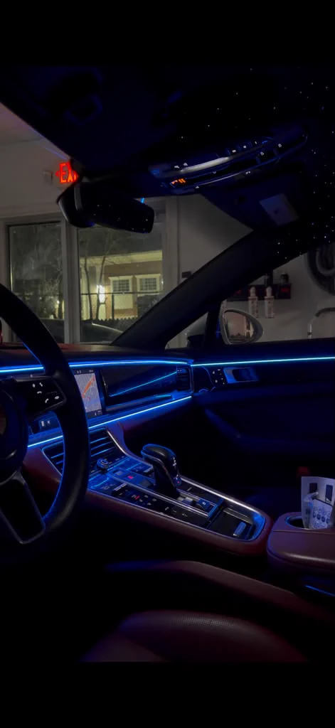 Blue ambient lighting running along the dash and doors