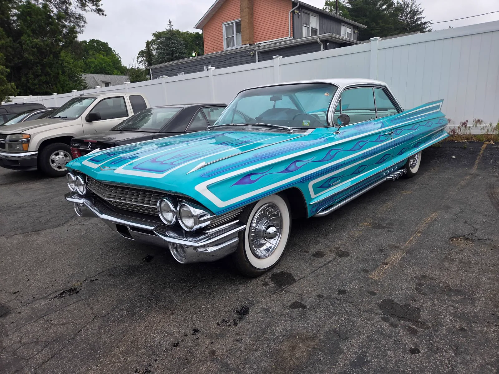 Restored turquoise classic Cadillac convertible in the lot