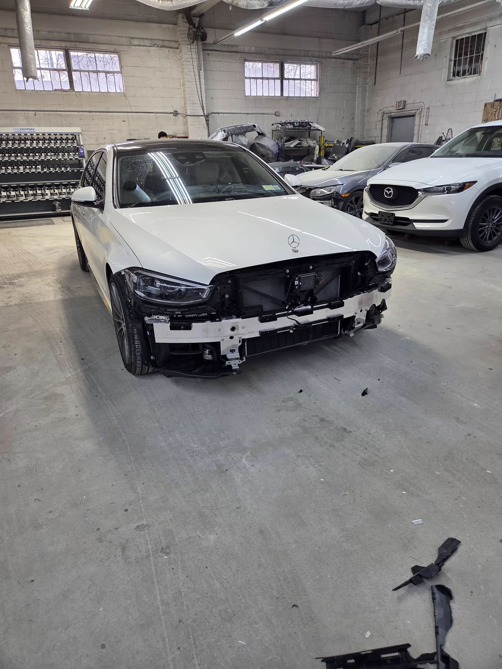 White Mercedes with the front end torn off after a collision
