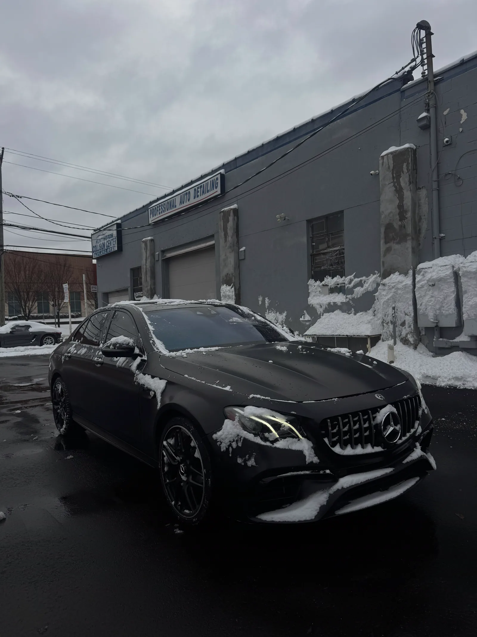 Matte black Mercedes-AMG E63 outside the shop