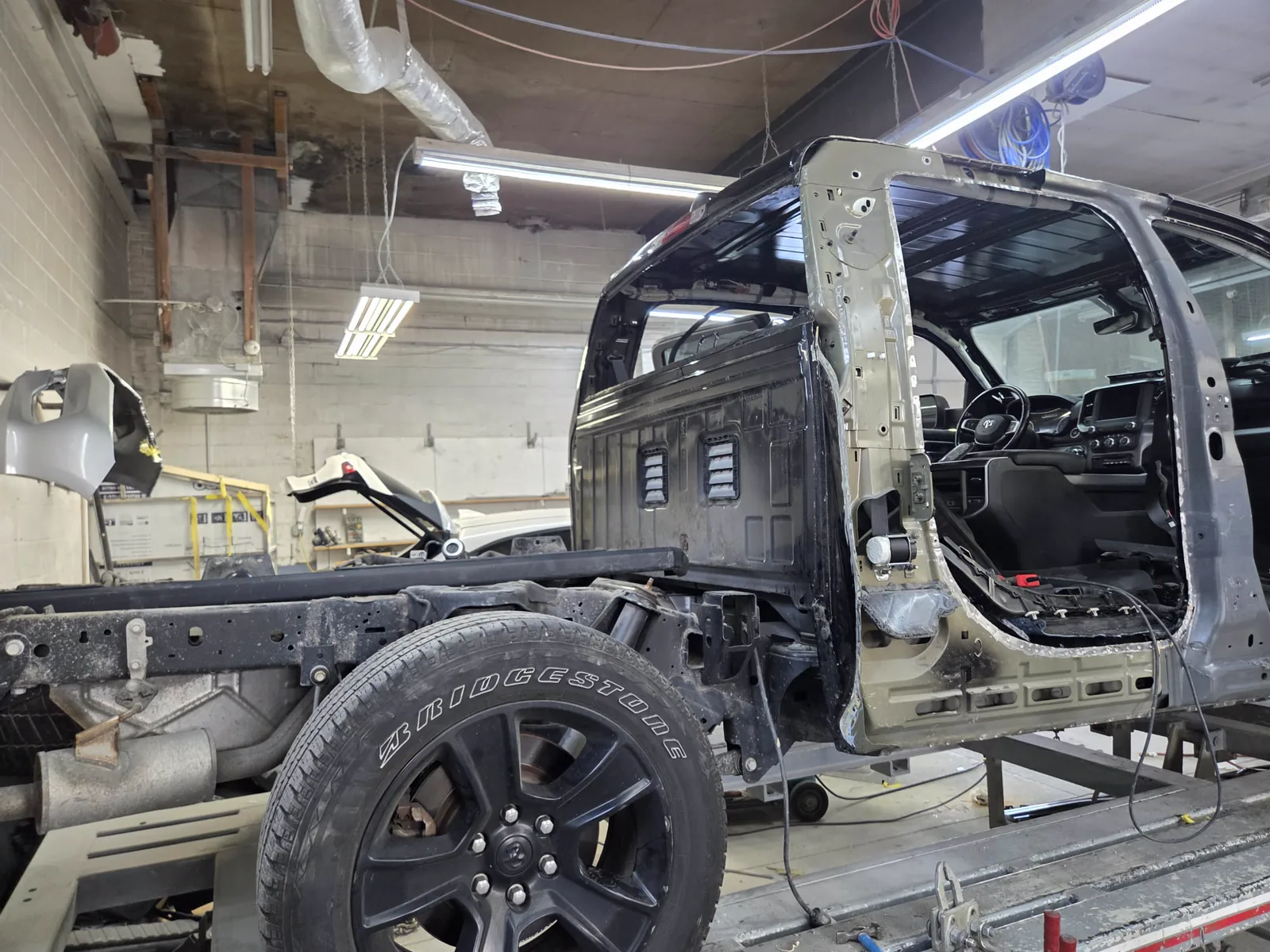 Vehicle stripped to the shell on the frame bench
