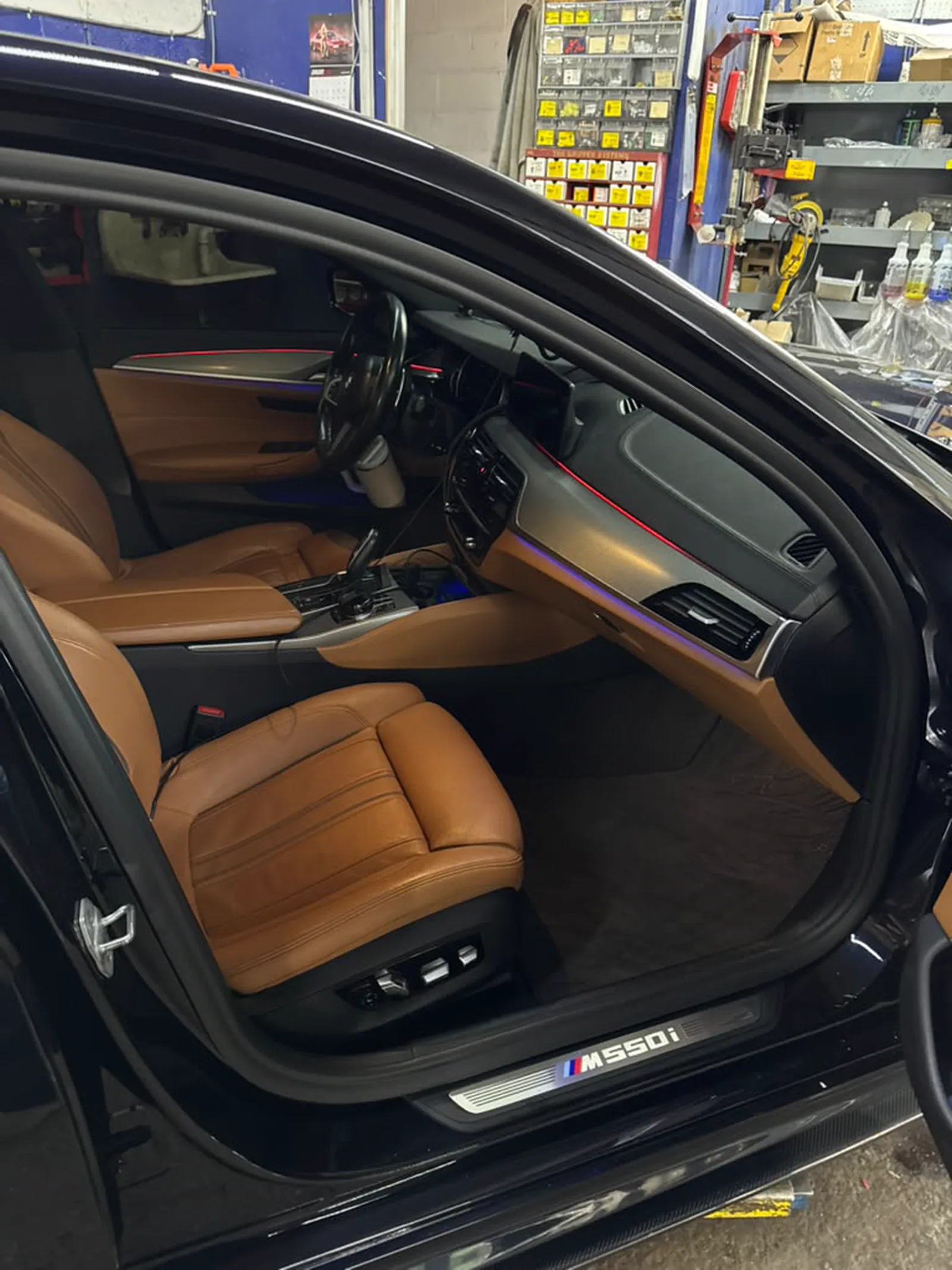 Tan leather interior with ambient lighting along the dash