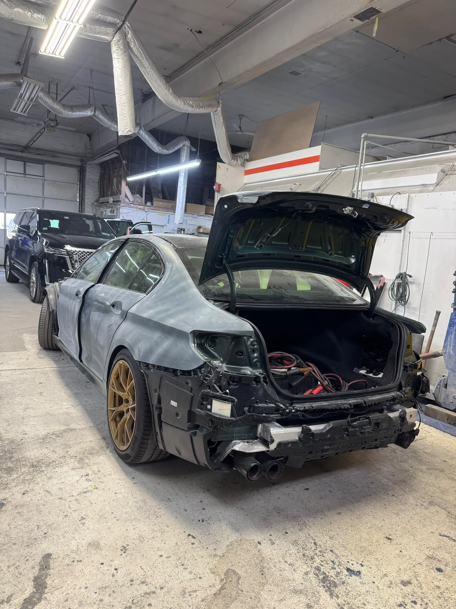 BMW M5 rear quarter sanded to bare primer