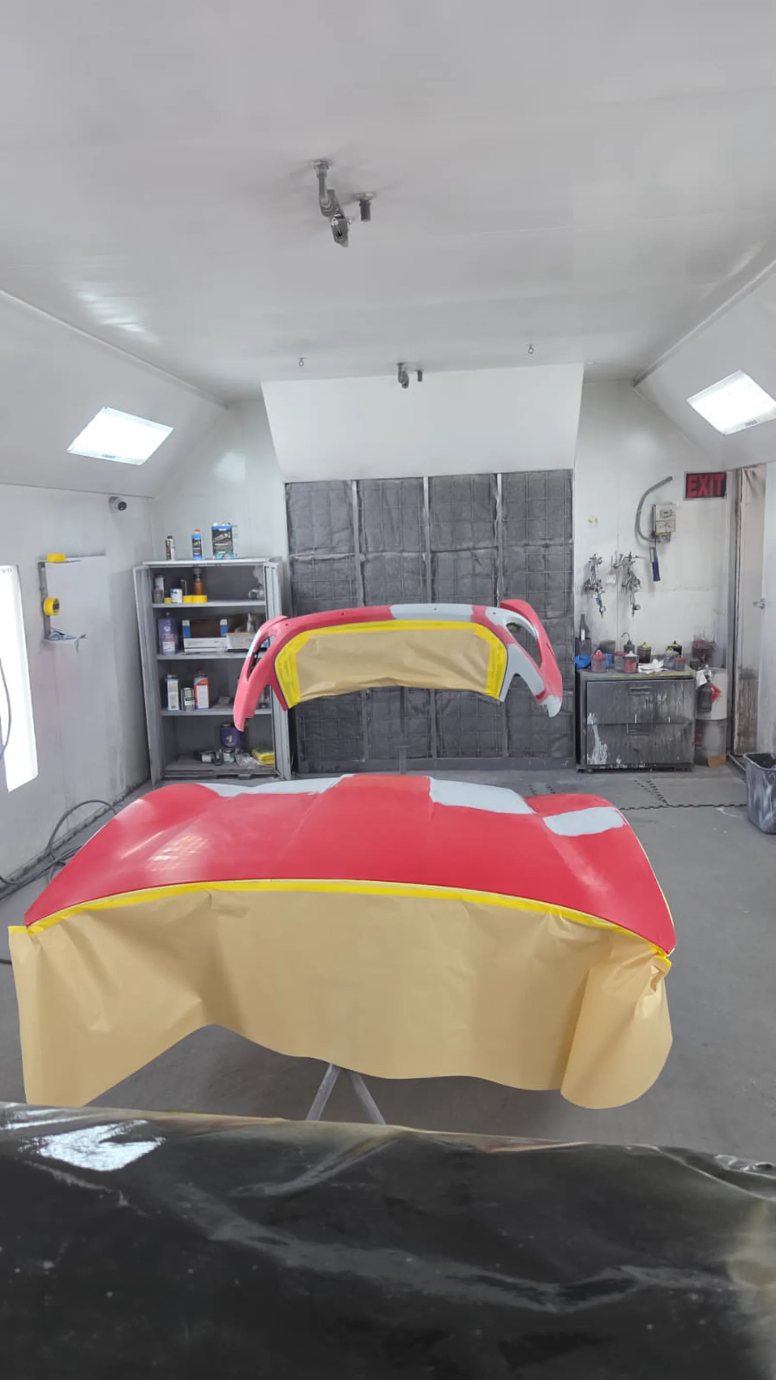 Panel in primer and colour inside the sealed paint booth