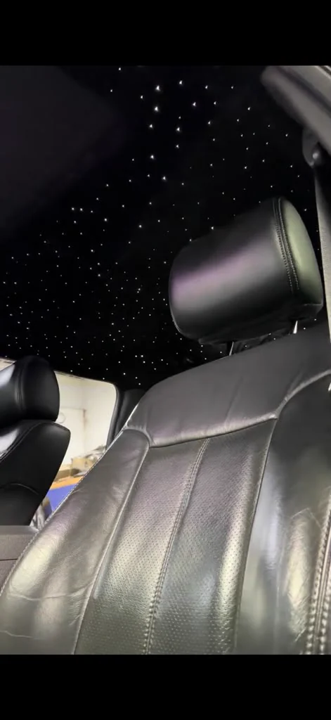 Fibre-optic starlight headliner lit above leather seats