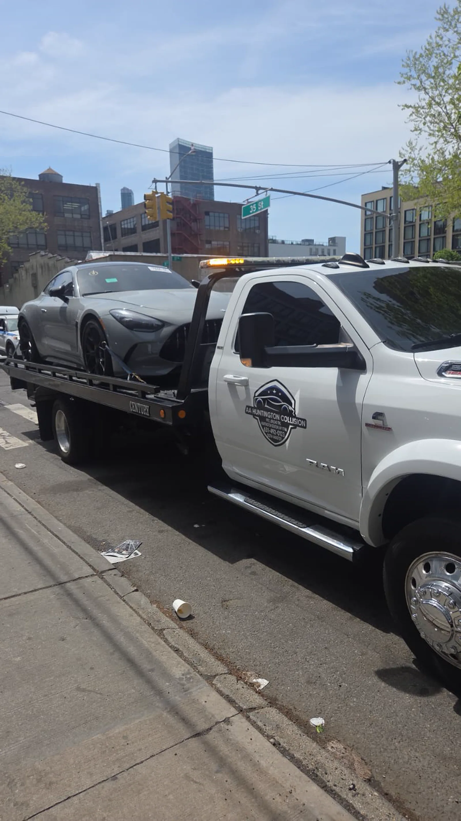 Huntington Collision flatbed loaded with a customer car
