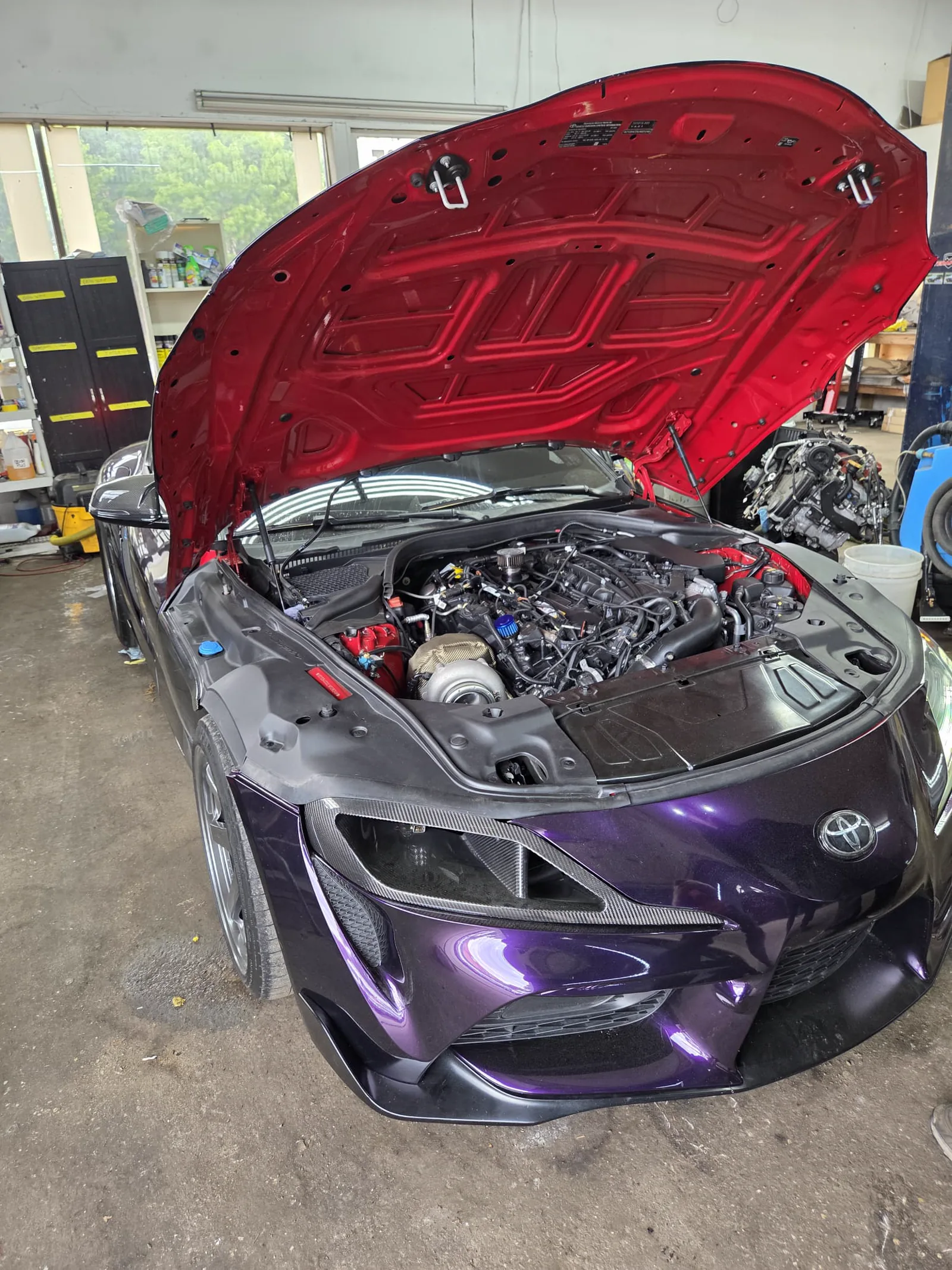 Mercedes in a purple colour-shift vinyl wrap, hood raised